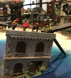 The archers take up a vantage point on a wrecked building, with Hugo de Moncada offering moral support.